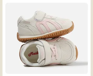Detailed macro view of cream children's fashion sneakers with pink accents