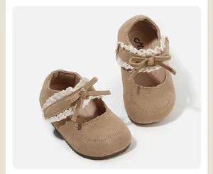 Detailed view of beige suede toddler girls princess shoes with lace and bow