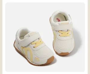 Detail of white kids sneakers with yellow accents and comfortable anti-slip gum sole