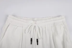 Detail view of white corduroy elastic waistband with drawstring and black tips