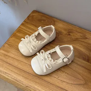 Elegant cream girls Mary Jane flat shoes with lace trim, bow detail, and soft soles