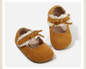Detailed macro view of yellow suede baby Mary Jane shoes with lace and bow