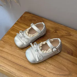 Elegant silver metallic Mary Jane shoes for girls featuring lace trim and cute bow accent