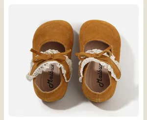 Detailed view of yellow suede toddler walking shoes with lace trim and sweet bow