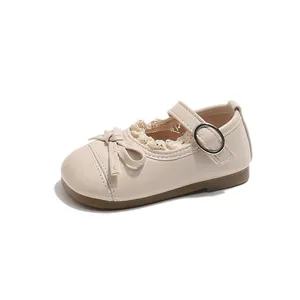 Cream girls Mary Jane shoes with lace trim and bow detail on a white background