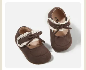 Classic brown suede baby girl Mary Jane shoes with white lace trim and bow detail