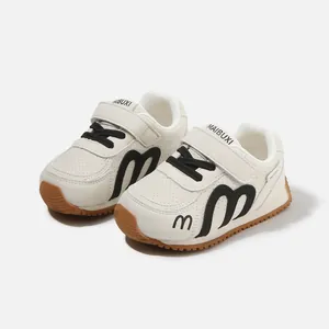 Stylish white children's sports sneakers with black M logo and non-slip rubber gum sole