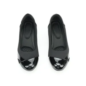 Overhead view of elegant black slip-on work shoes with glossy patent leather toe cap