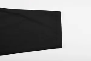 Detailed macro view of the black corduroy fabric texture for men's summer casual clothing.
