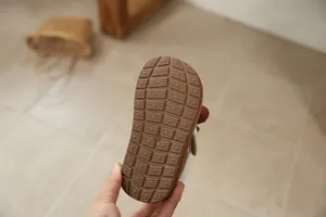 Detailed close-up of the anti-slip rubber sole of girls' winter snow boots with size marking