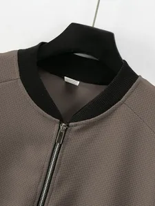 Detailed close-up of men's waffle knit jacket neckline and metallic zipper closure