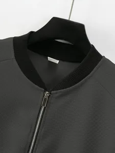 Detailed close-up of a men's waffle knit jacket with metal zipper and ribbed collar