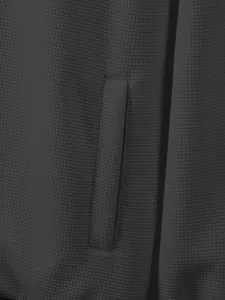 Close-up of charcoal waffle knit fabric and pocket detail on men's winter jacket