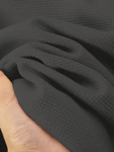 Close-up of dark grey waffle knit fabric texture on men's winter jacket