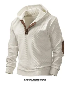 Detailed view of the jacquard texture and button collar on a men's cream hoodie