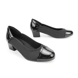 Close-up detail of stylish black retro pumps featuring square toe and block heels