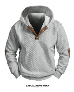 Close-up of men's gray jacquard hoodie with brown faux suede elbow patches