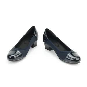 Close-up of navy blue block heel pumps featuring a glossy patent leather square toe