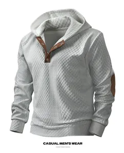 Close-up detail of men's casual jacquard hoodie featuring textured knit and patches