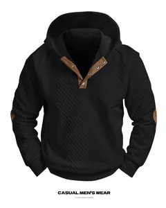 Detail view of men's black jacquard hoodie featuring buttoned henley neck and suede patches