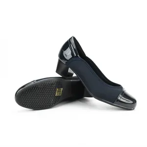 Close-up detail of navy blue square toe block heel pumps with anti-slip rubber sole