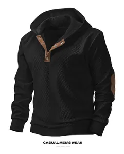 Macro view of black men's hoodie showing jacquard texture and brown button collar detail
