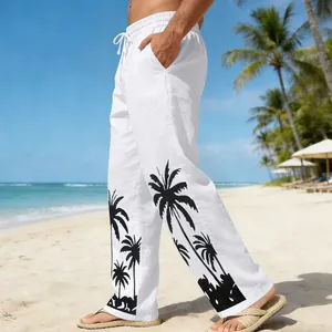Close-up of white men's beach trousers featuring black palm tree prints on the legs