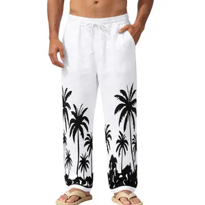 Detail of men's white beach pants featuring a black palm tree print at the hem.