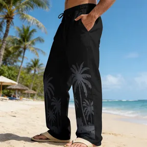 Close-up of men's black beach trousers featuring a stylish grey palm tree print design
