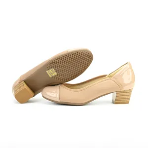 Elegant nude patent leather square-toe pumps with chunky mid-heels in a vintage style.