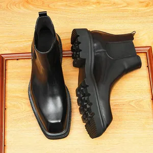 Classic black leather Chelsea boots with square toe and thick lugged sole for men.
