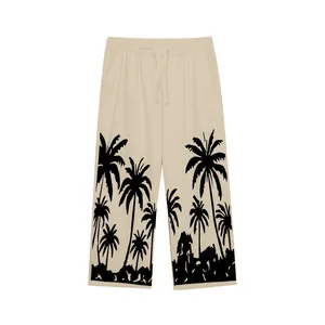 Detail of men's casual beach pants featuring a bold black palm tree silhouette print.