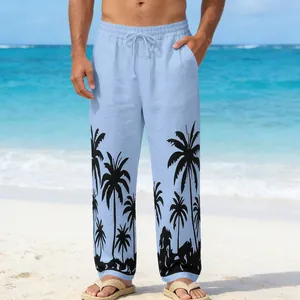 Detailed view of blue beach pants for men featuring palm tree prints and drawstring waist.