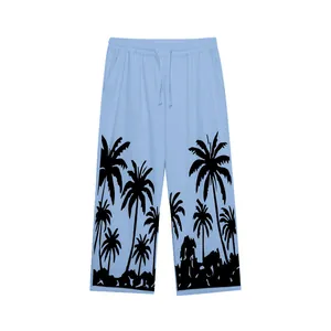 Light blue men's beach pants with black palm tree silhouette print and drawstring waist.