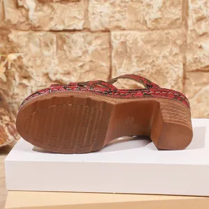 Detailed macro view of brown anti-slip rubber sole on snakeskin platform sandals