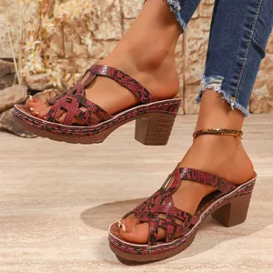 Detail view of red snakeskin patterned platform sandals with thick heels