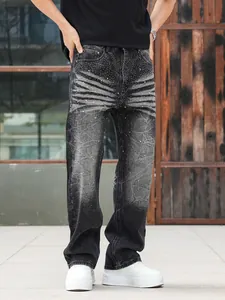 Close-up detail of black washed denim jeans featuring heavy rhinestone embellishments on front