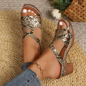 Detail showing metallic snake skin print on platform Roman sandals for women