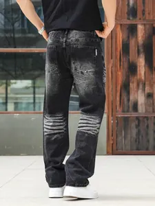 Back view of men's heavy washed black grey straight leg jeans with rhinestone details