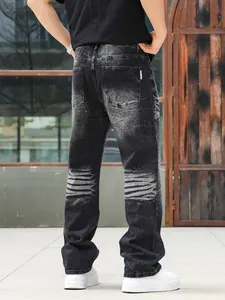 Men's washed black straight jeans with heavy rhinestone details and relaxed fit back view