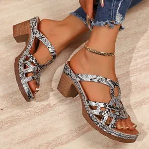 Detail showing the snakeskin textured straps and chunky block heel of the sandals