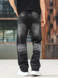 Detailed back view of men's loose straight-leg jeans in heavy washed black grey denim