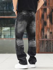 Back view of men's washed black straight loose fit denim jeans with heavy wash detail