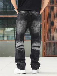 Back view of men's loose straight black washed jeans with distressed knee details