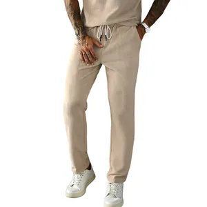 Men's khaki corduroy straight-leg casual pants with drawstring waist and white sneakers