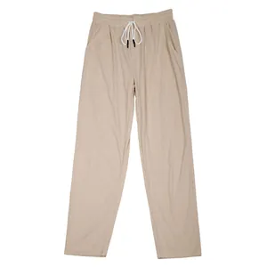 Close-up detail of beige men's corduroy casual pants with drawstring straight leg fit