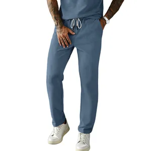 Detail showing the blue corduroy fabric texture and drawstring waist of the men's pants.