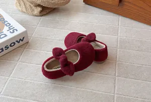 Detailed close-up view of wine red velvet girls' fuzzy winter shoes featuring a cute bow
