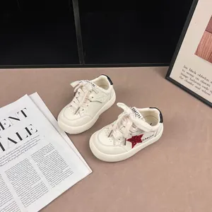 Trendy white children's sneakers featuring a red glitter star and classic lace-up style.