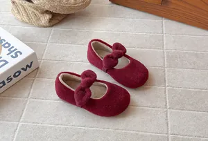 Close-up view of girls' warm burgundy plush Mary Jane shoes with bow-knot detail